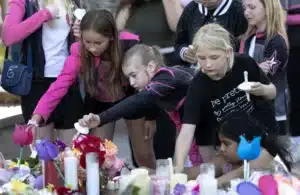 People console one another during a vigil to remember the Decker...