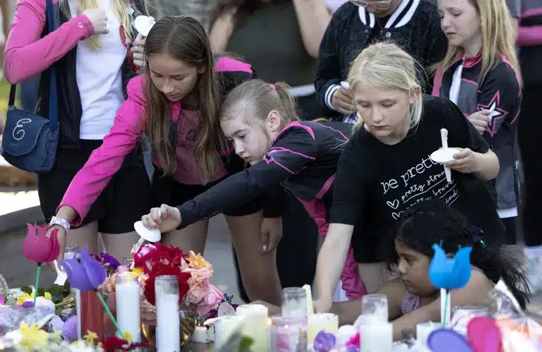People console one another during a vigil to remember the Decker...