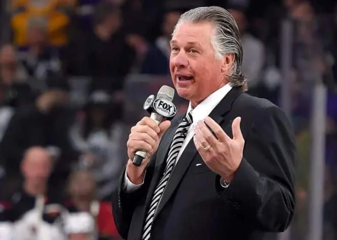 Barry Melrose speaks to fans as he is honored before a game between the Kings and the Calgary Flames in 2015. (Mark J. Terrill / AP)